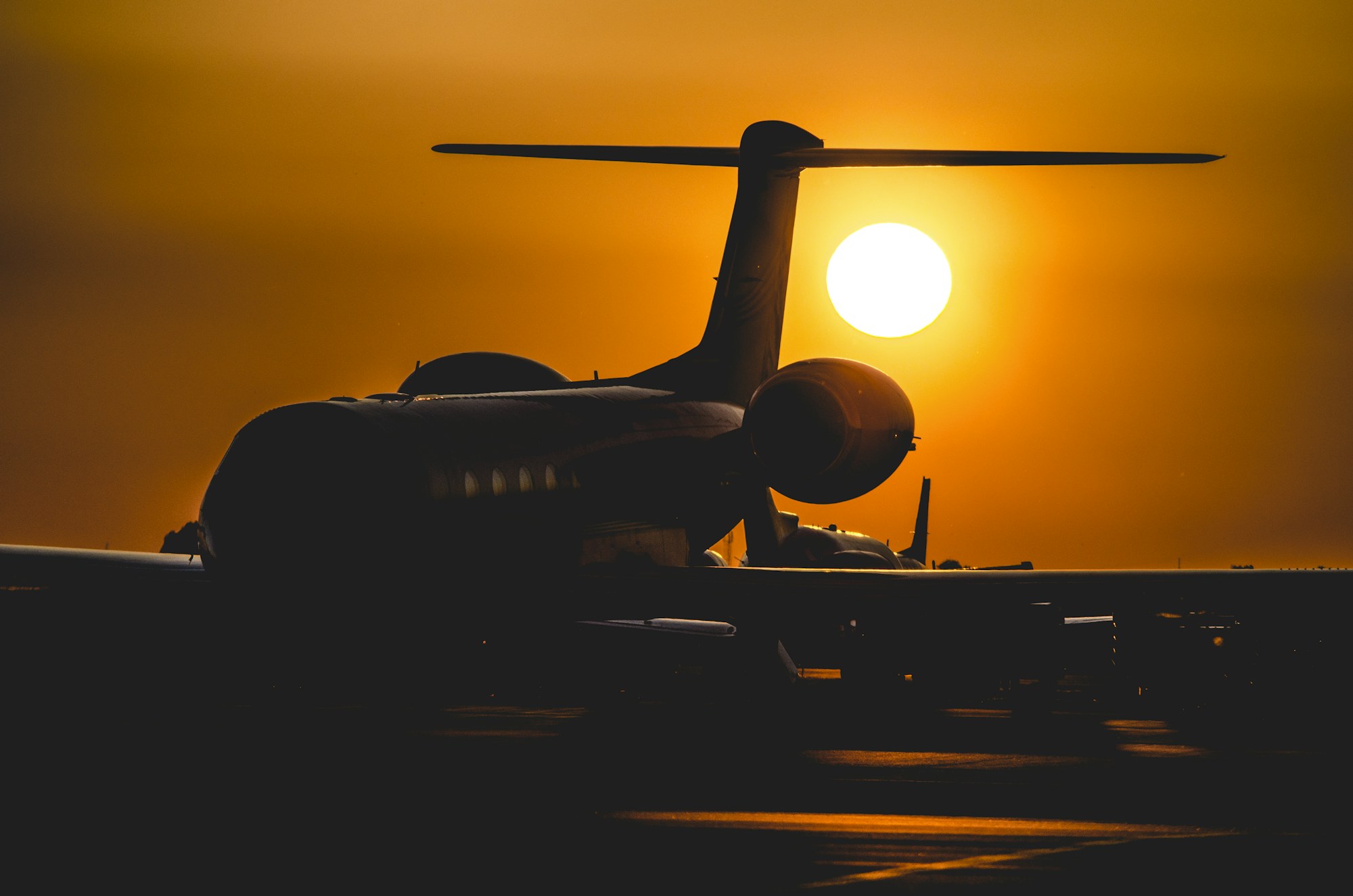 Business jet silhouetted against the setting sun