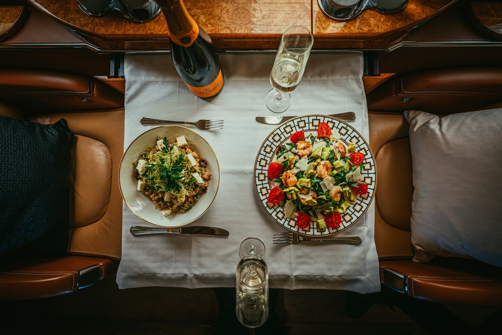 Table setting with plates and wine aboard a private jet