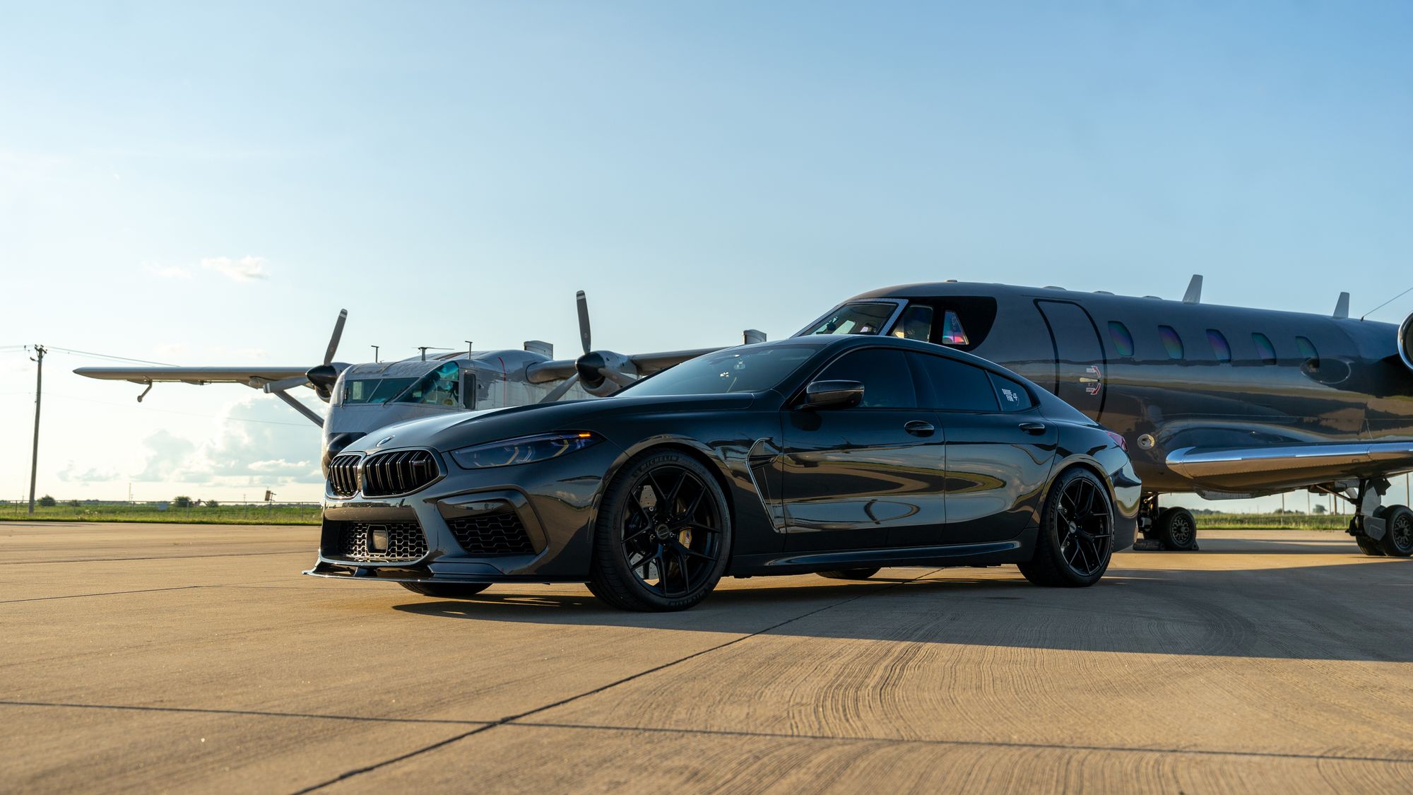 Chauffeured car beside a private jet